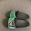 Black and green Nike slides