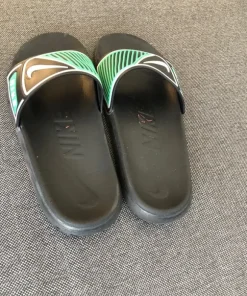 Black and green Nike slides