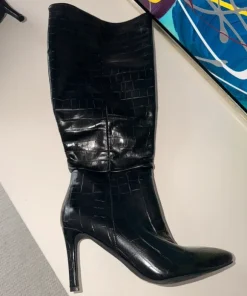 Black knee-high boots with crocodile texture