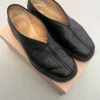 Piped leather slip-on shoes