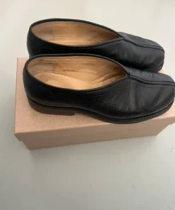 Piped leather slip-on shoes